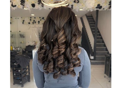 Elegant curled hairstyle at Shelbi Halewood Hair, Prestwich, England, GB.