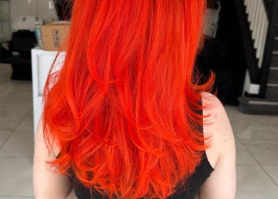 Vibrant red hair styled at Shelbi Halewood Hair in Prestwich, England, GB.