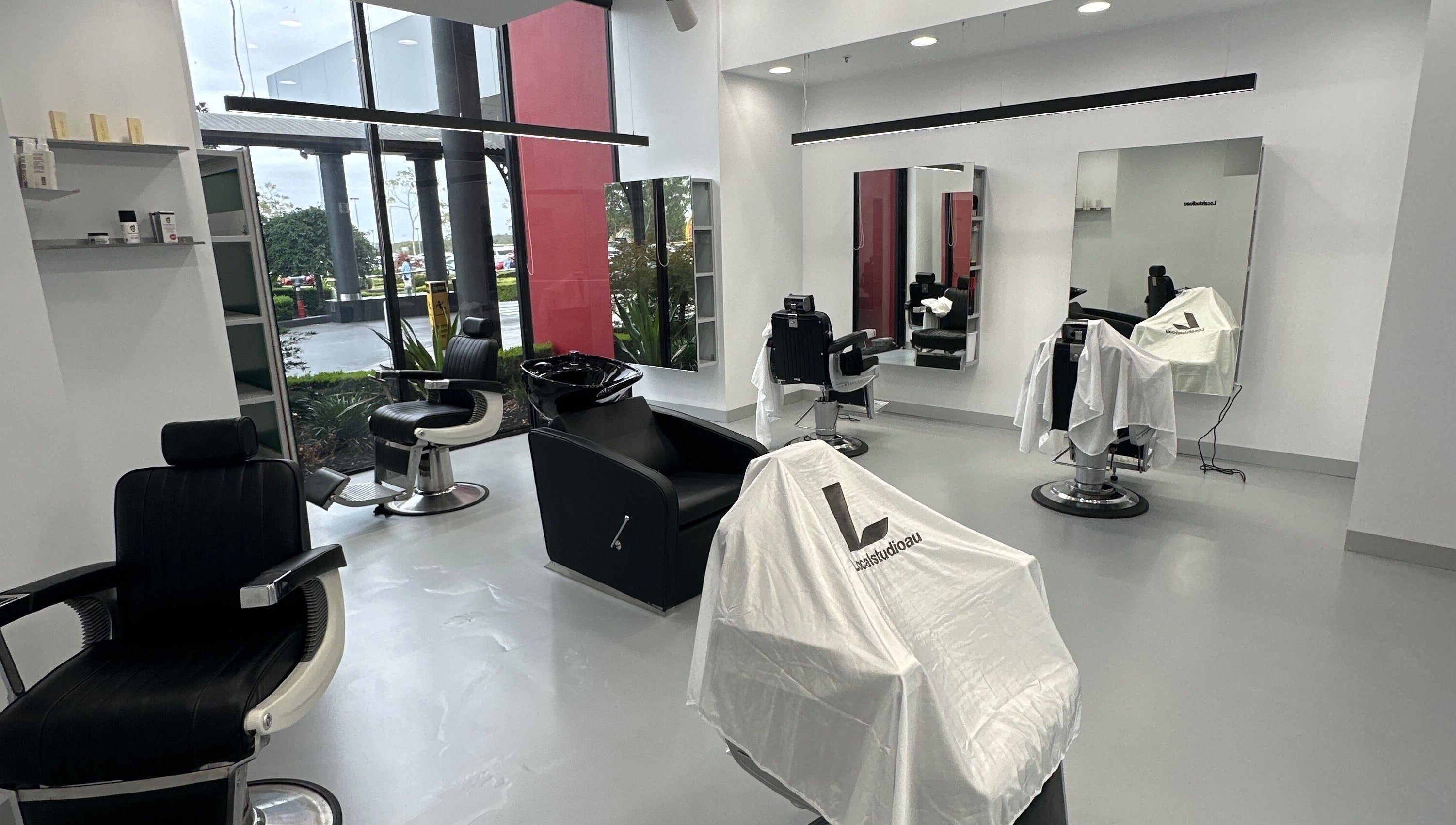 Modern salon interior at Localstudioau, Bossley Park, New South Wales, AU with chic black velvet chairs.