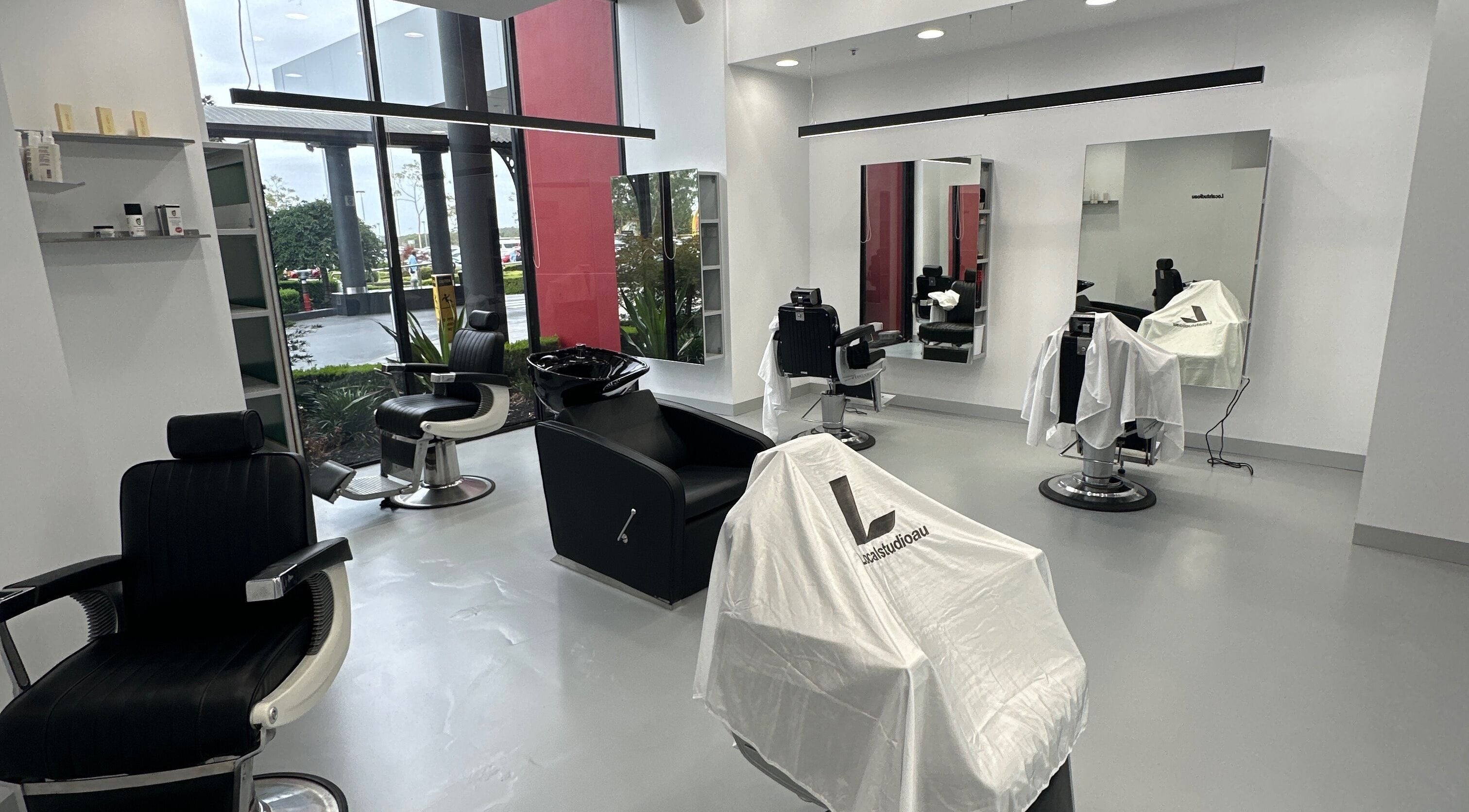 Modern salon interior at Localstudioau, Bossley Park, New South Wales, AU with chic black velvet chairs.