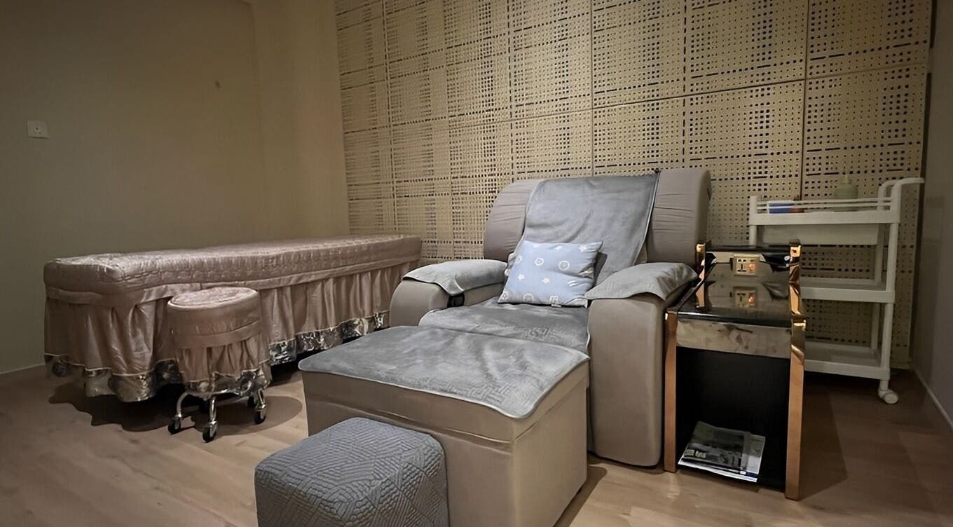 Luxurious therapy room at Zenn Harmony Healing, Kuala Lumpur, with a massage table and comfy chair.