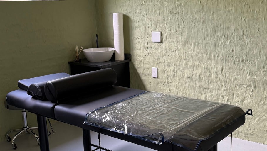 Tranquil massage room at Olive and Kai Beauty, Midrand, Gauteng, ZA, featuring a massage table and soft lighting.