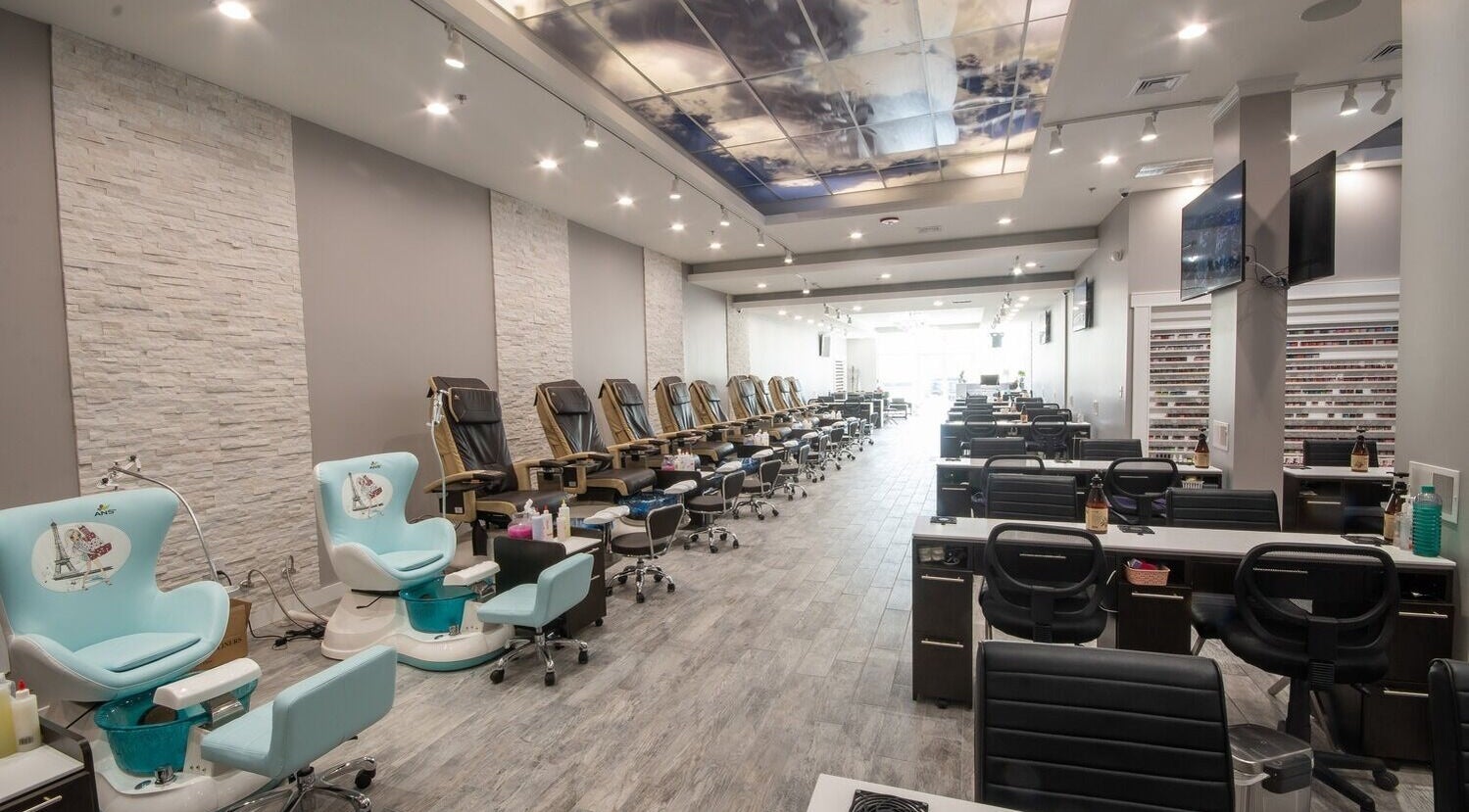 Modern nail salon interior at Glossy Nails Manchester, Manchester, New Hampshire, US with chic pedicure stations.