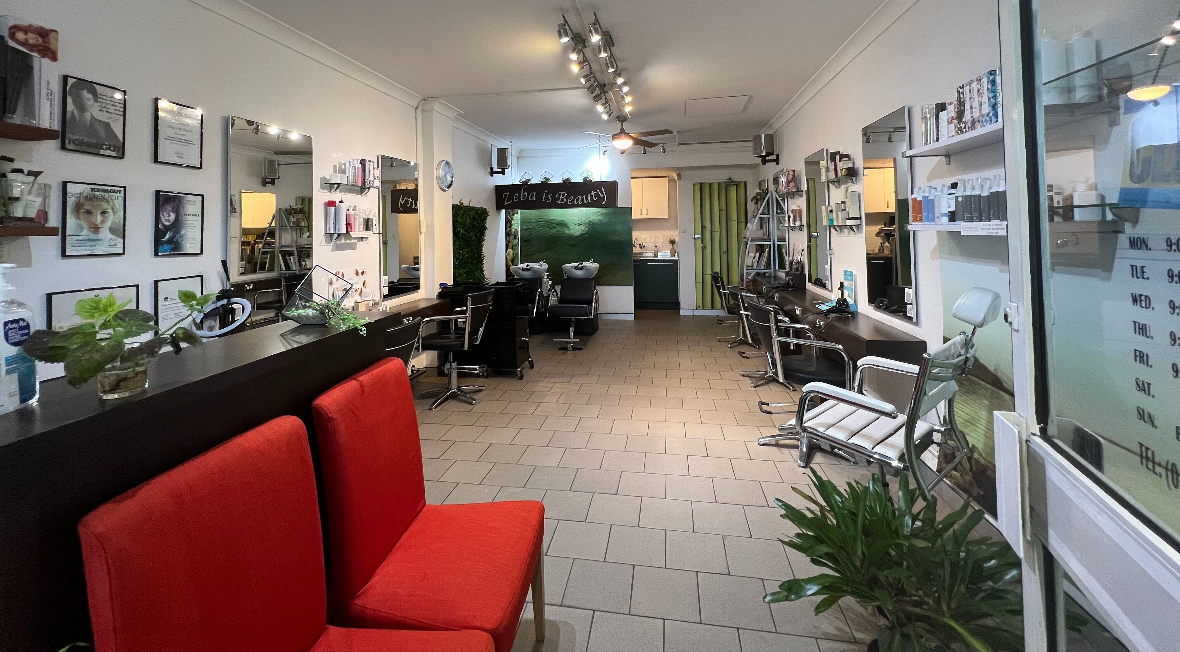 Elegant interior of Zeba Hair Studio, Rose Bay, New South Wales, AU. Stylish seating and sleek decor.