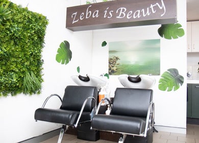 Relaxing hair washing area at Zeba Hair Studio in Rose Bay, New South Wales, AU, featuring lush green décor.