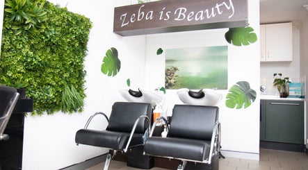 Relaxing hair washing area at Zeba Hair Studio in Rose Bay, New South Wales, AU, featuring lush green décor.