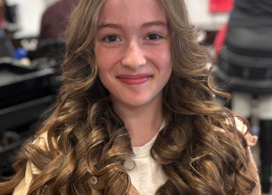 Smiling woman with styled curly hair at Zeba Hair Studio, Rose Bay, New South Wales, AU.