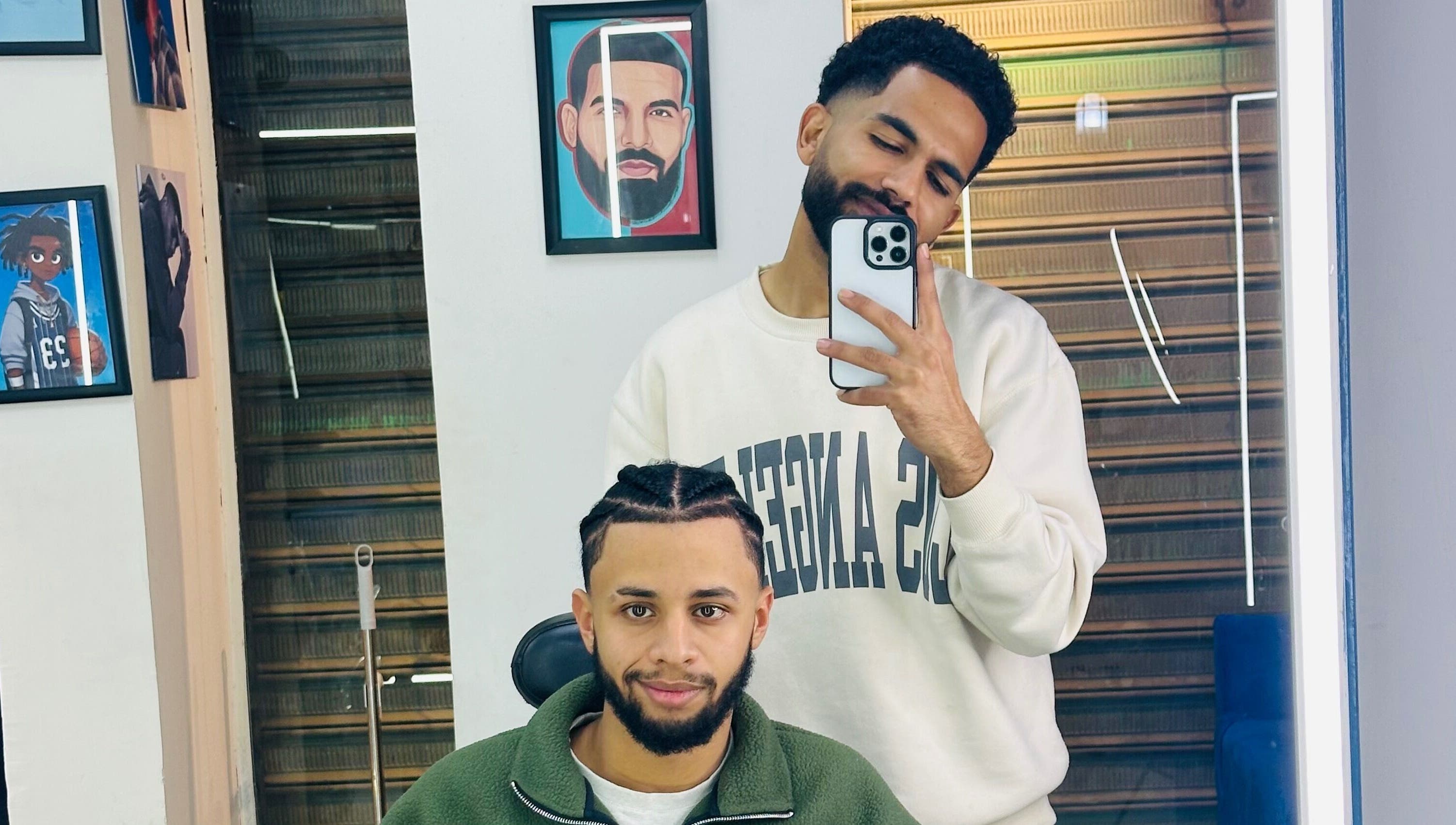 Two men at Hakim Hair Style in Cairo Governorate enjoying a fresh haircut and selfie moment.