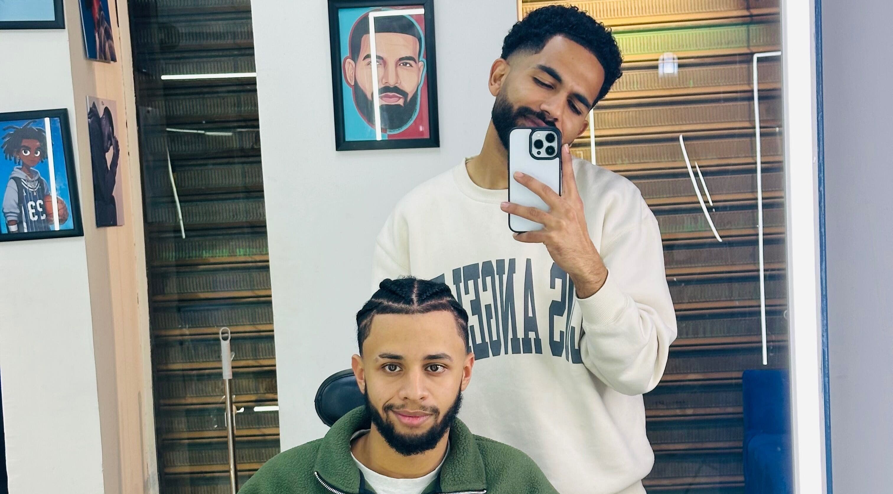 Two men at Hakim Hair Style in Cairo Governorate enjoying a fresh haircut and selfie moment.