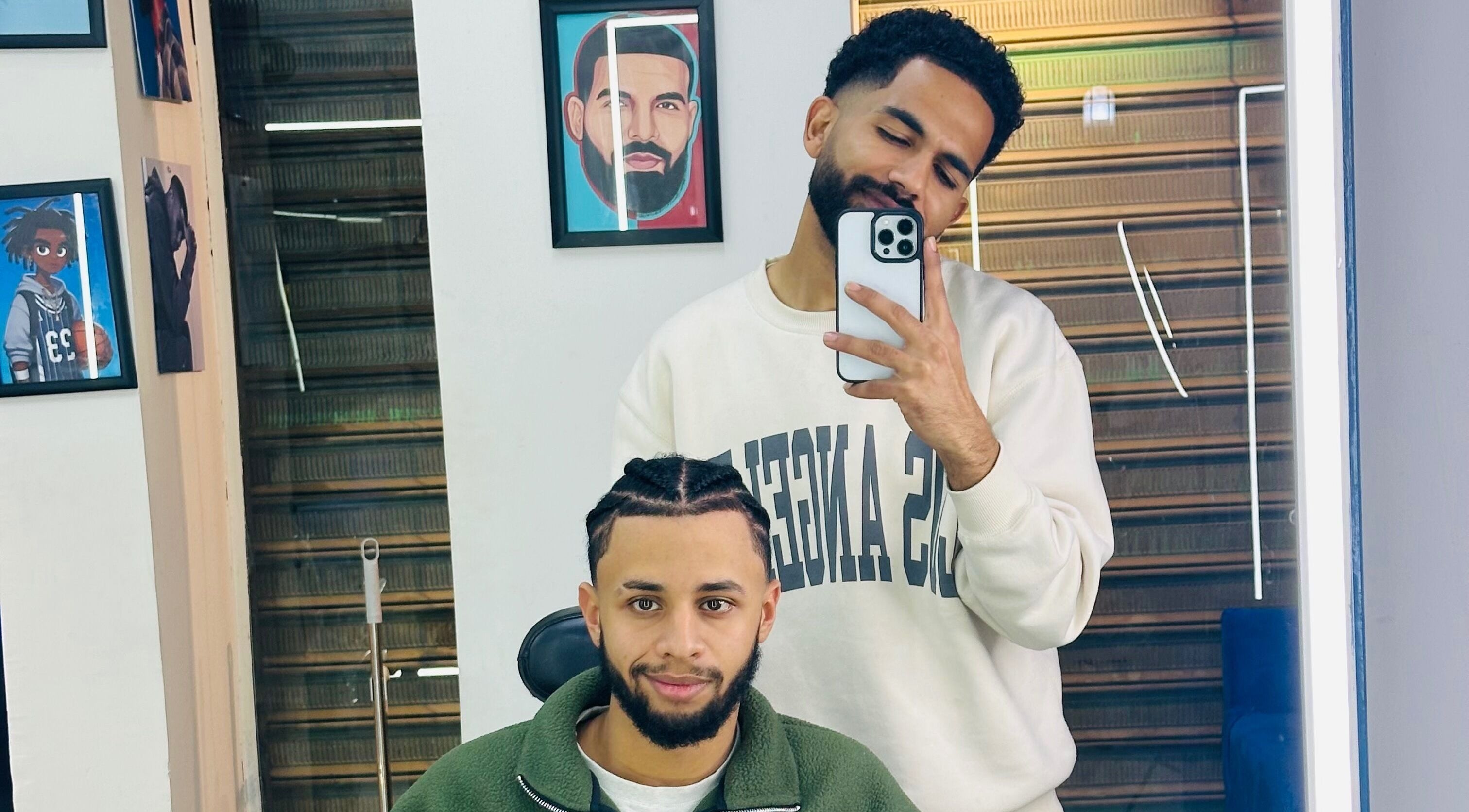 Two men at Hakim Hair Style in Cairo Governorate enjoying a fresh haircut and selfie moment.