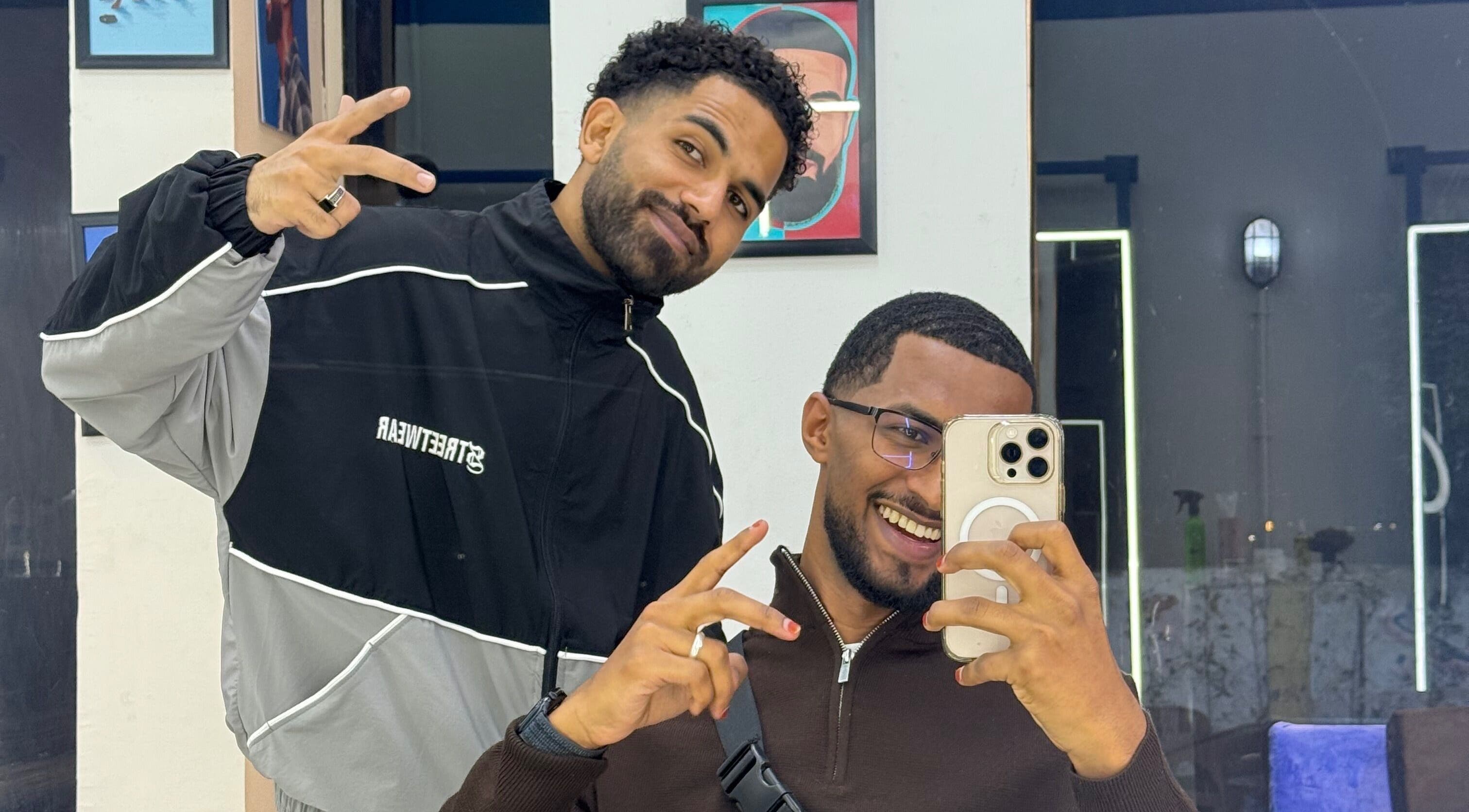 Two smiling men posing at Hakim Hair Style in Cairo Governorate, Cairo Governorate, EG.