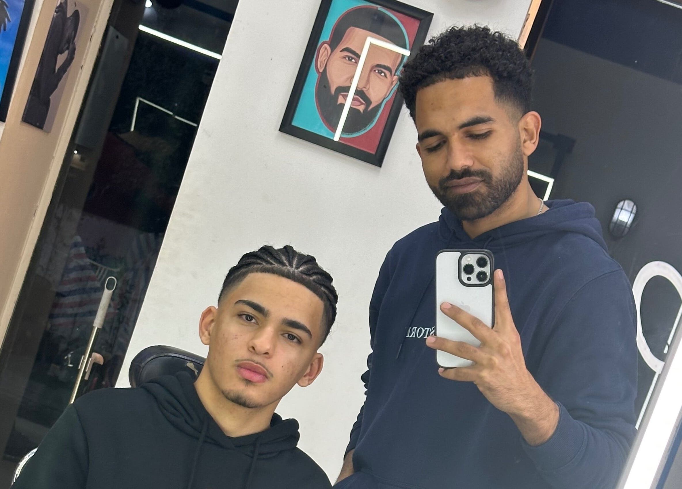 Barber and client in a mirror at Hakim Hair Style, Cairo Governorate, Cairo Governorate, EG.