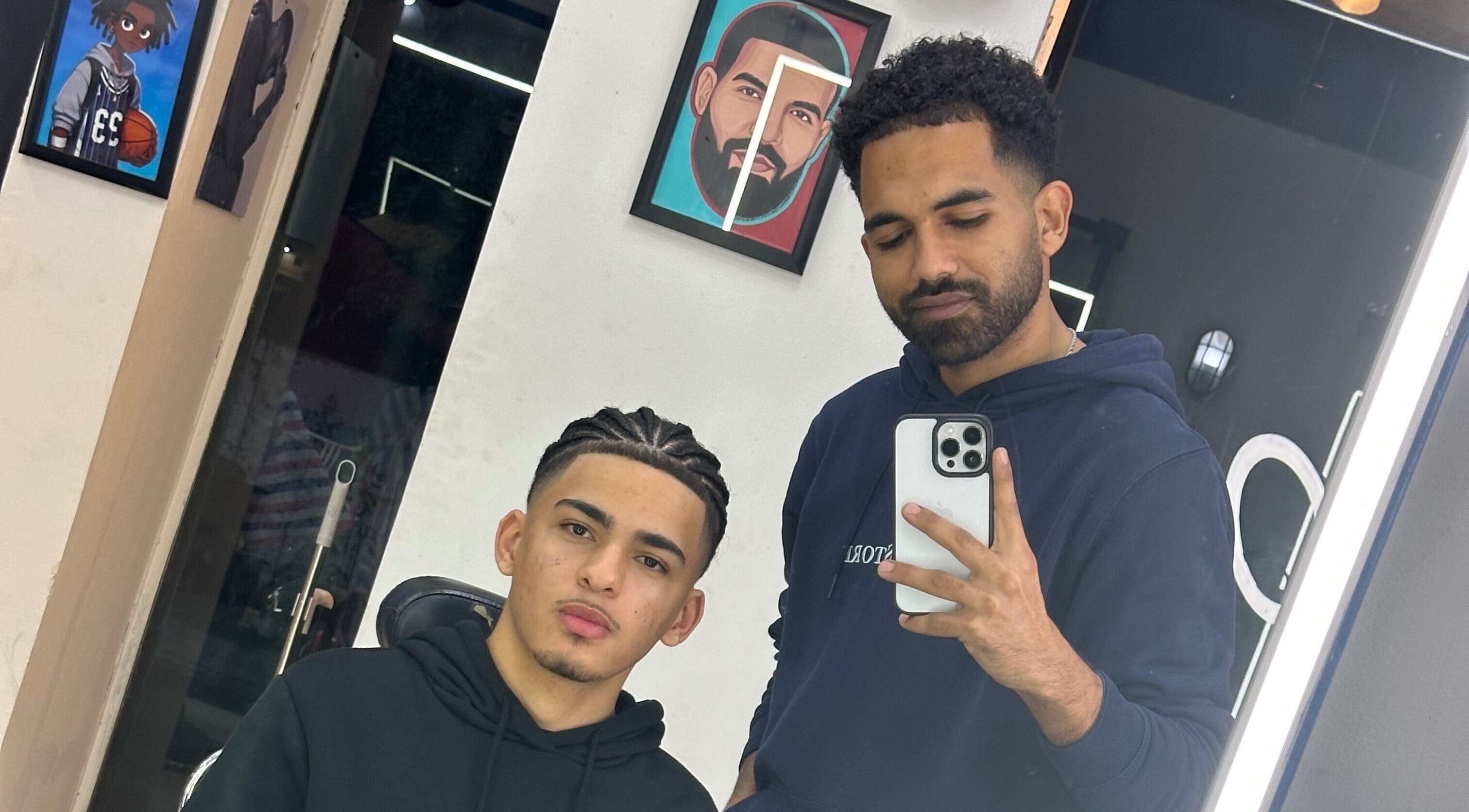 Barber and client in a mirror at Hakim Hair Style, Cairo Governorate, Cairo Governorate, EG.