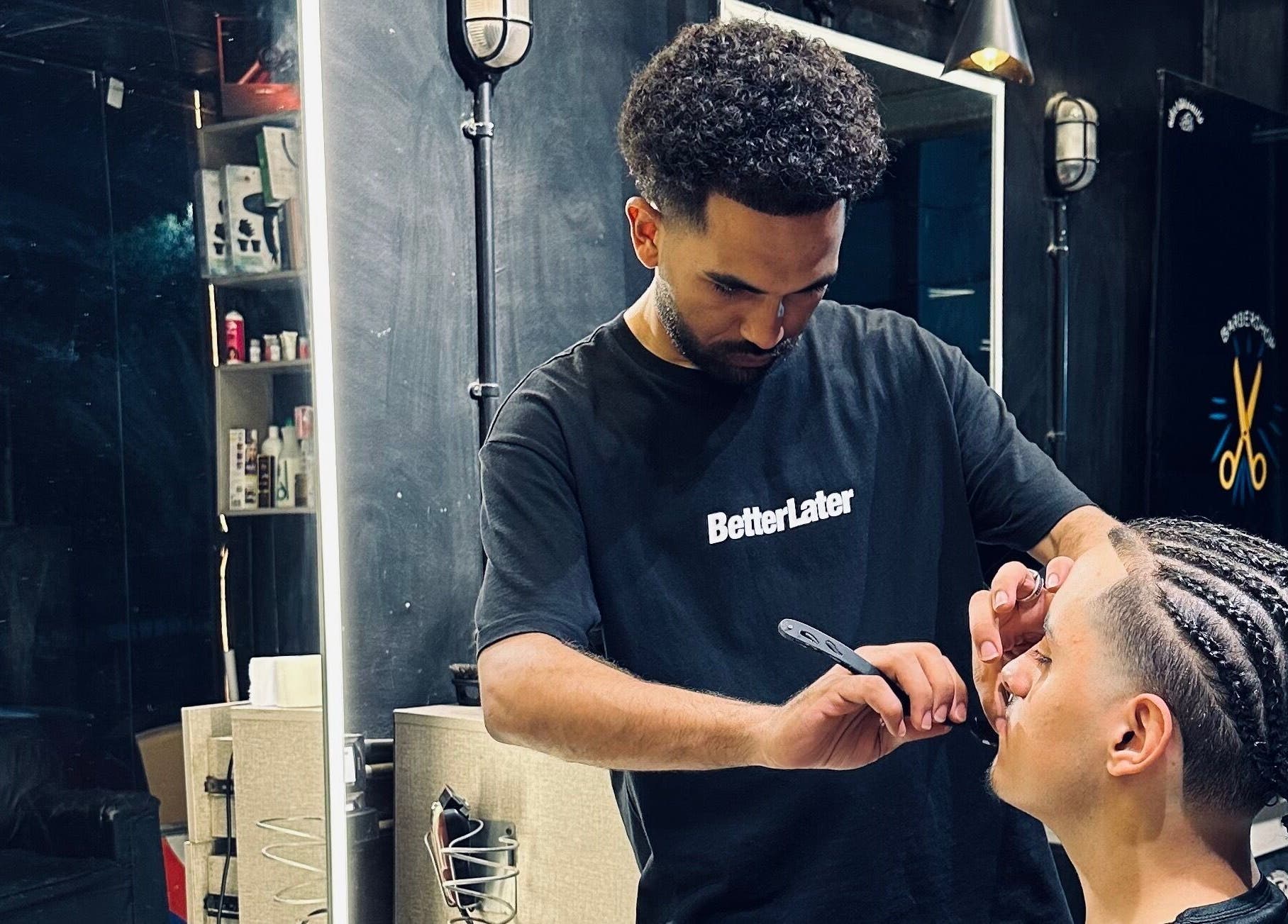 Stylist creating intricate braids at Hakim Hair Style, Cairo Governorate, Cairo Governorate, EG.