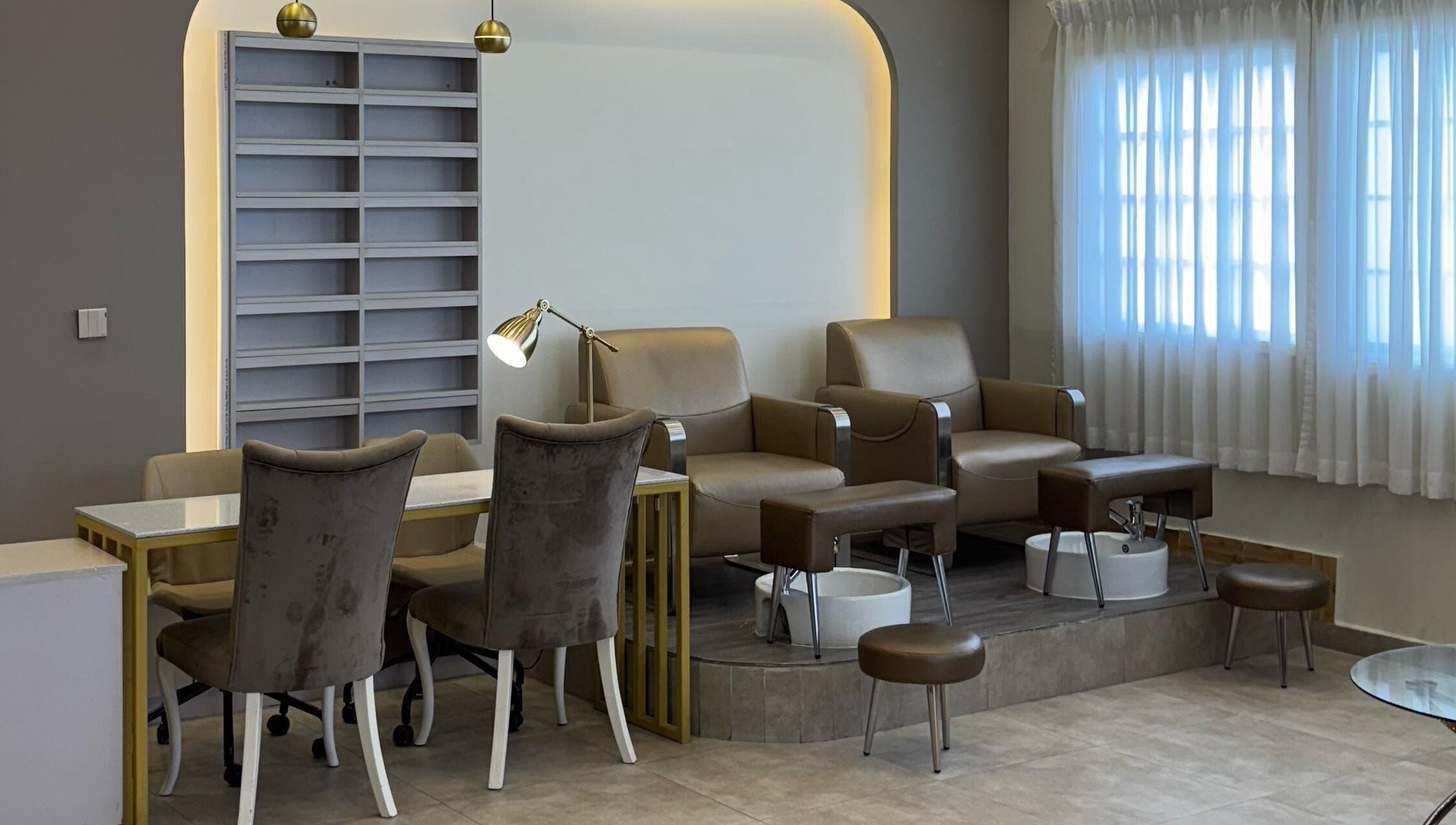 Stylish pedicure area at Farzaneh beauty salon, Muscat, Muscat, OM, featuring plush chairs and luxurious decor.