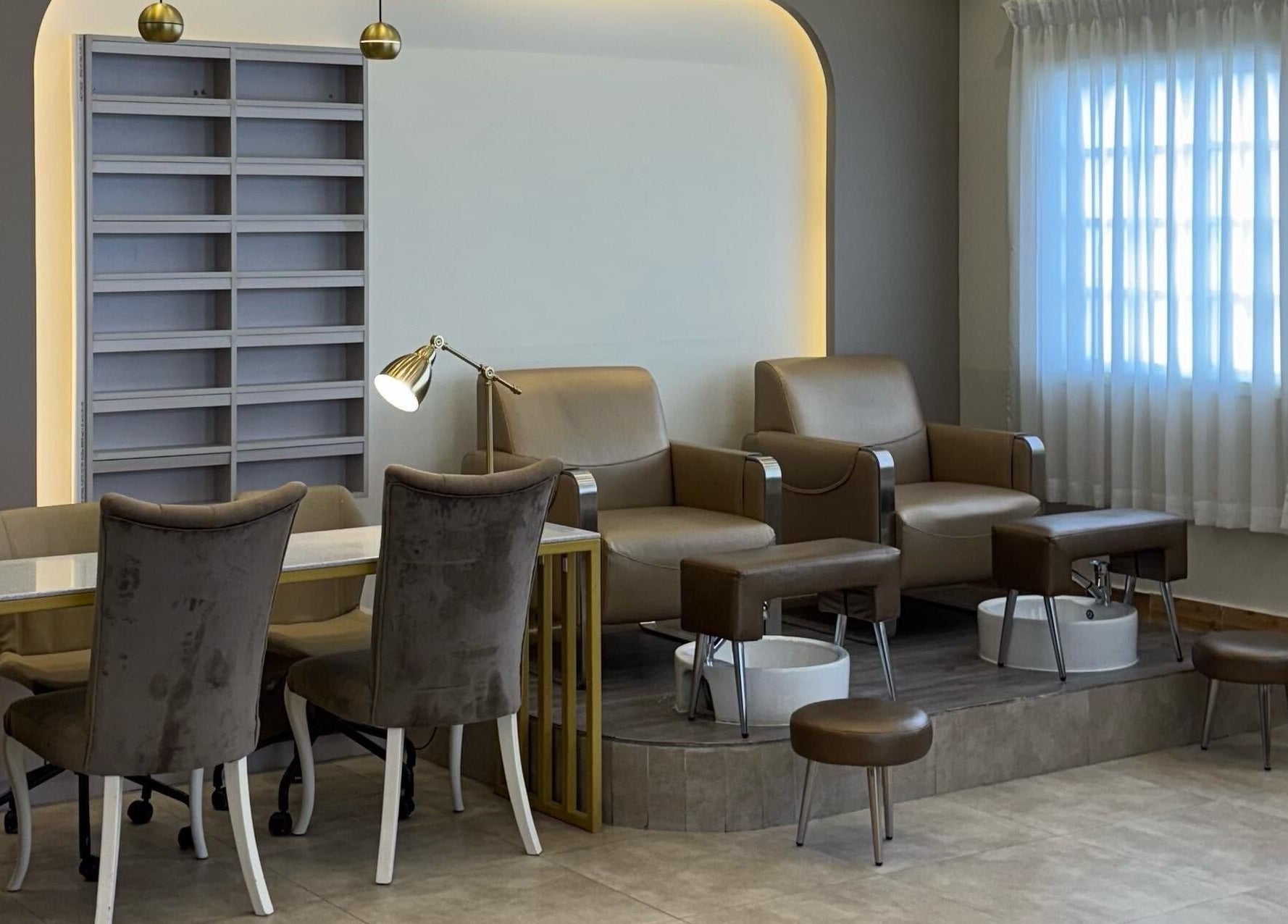 Stylish pedicure area at Farzaneh beauty salon, Muscat, Muscat, OM, featuring plush chairs and luxurious decor.