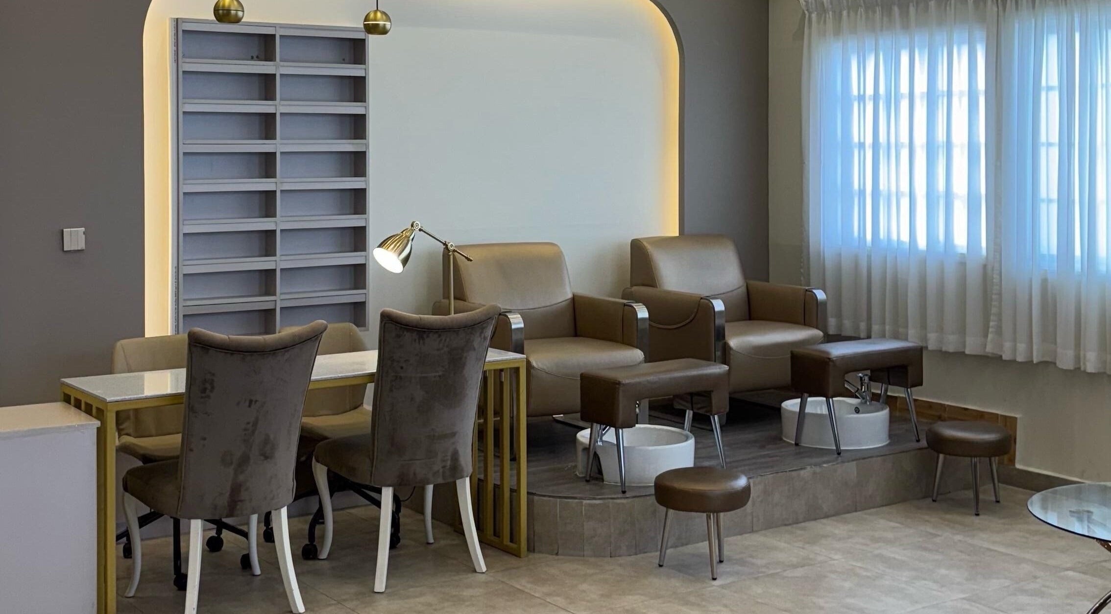Stylish pedicure area at Farzaneh beauty salon, Muscat, Muscat, OM, featuring plush chairs and luxurious decor.