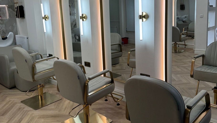 Modern salon interior at EMMLOU BEAUTY in Cheadle Hulme, England, GB with chic chairs and sleek mirrors.
