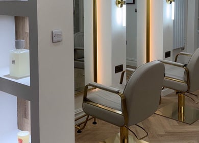 Modern salon chairs and mirrors at EMMLOU BEAUTY, Cheadle Hulme, England, GB, showcasing elegant interior design.