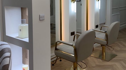 Modern salon chairs and mirrors at EMMLOU BEAUTY, Cheadle Hulme, England, GB, showcasing elegant interior design.