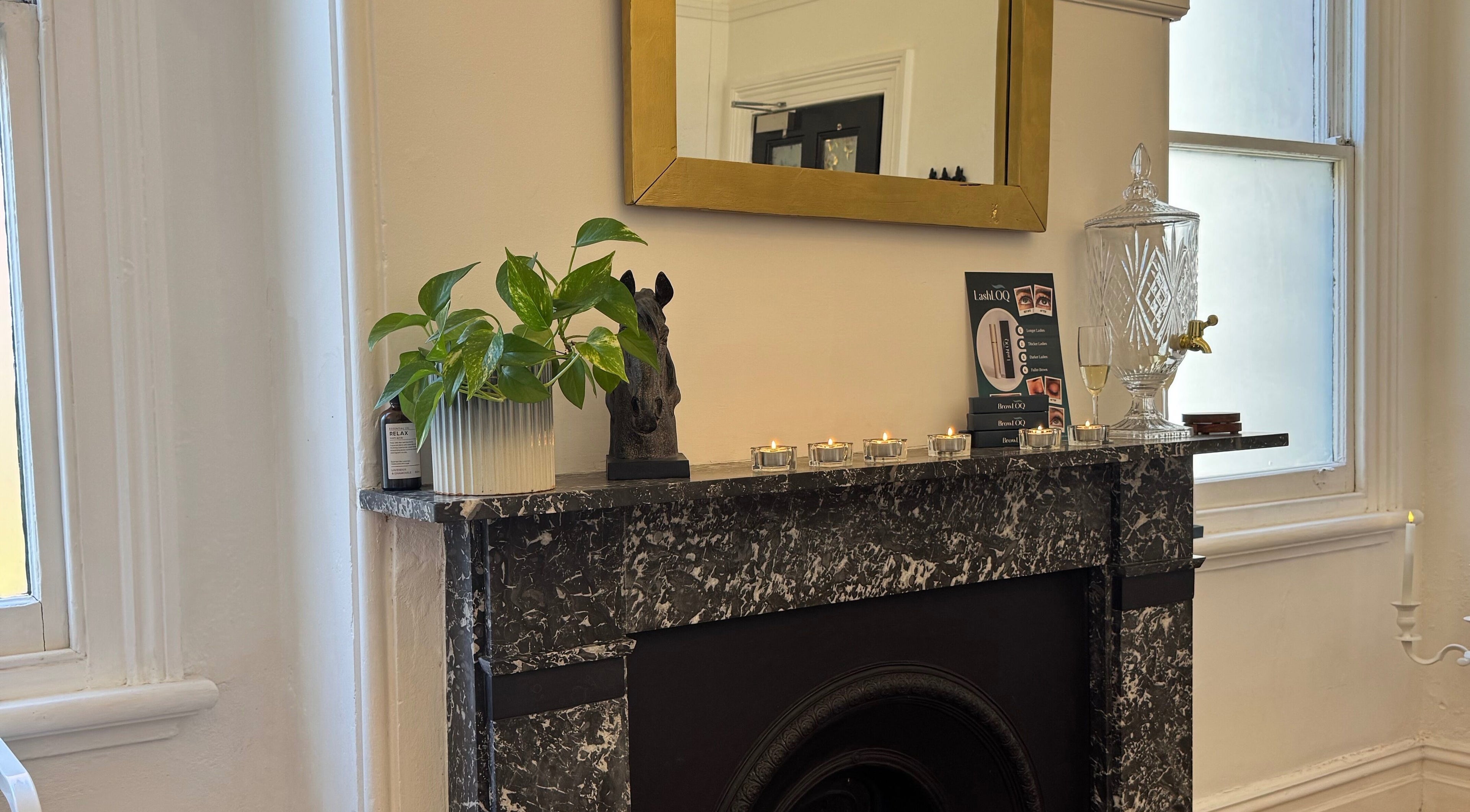 Elegant marble fireplace at Berry Aesthetic Clinic, Berry, New South Wales, AU with decor and candles.