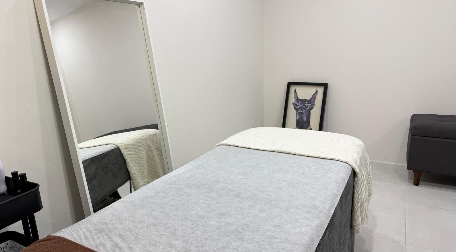 Treatment room at Face Correction Salon KOGAO in Singapore, SG, featuring serene decor and a cozy bed.