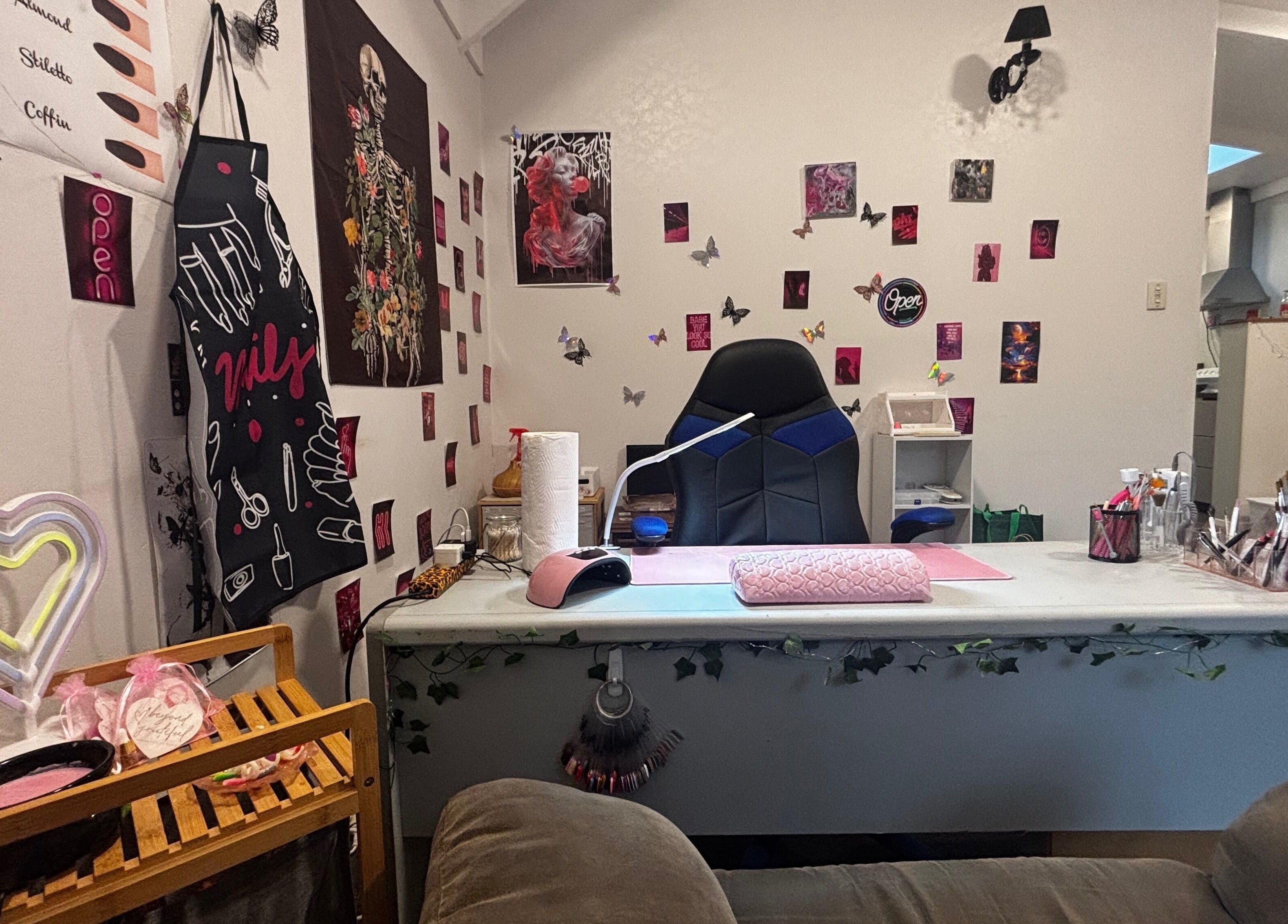 Stylish nail salon corner at Executive Elegance, Dunedin, Otago, NZ, adorned with butterfly art and neon decor.