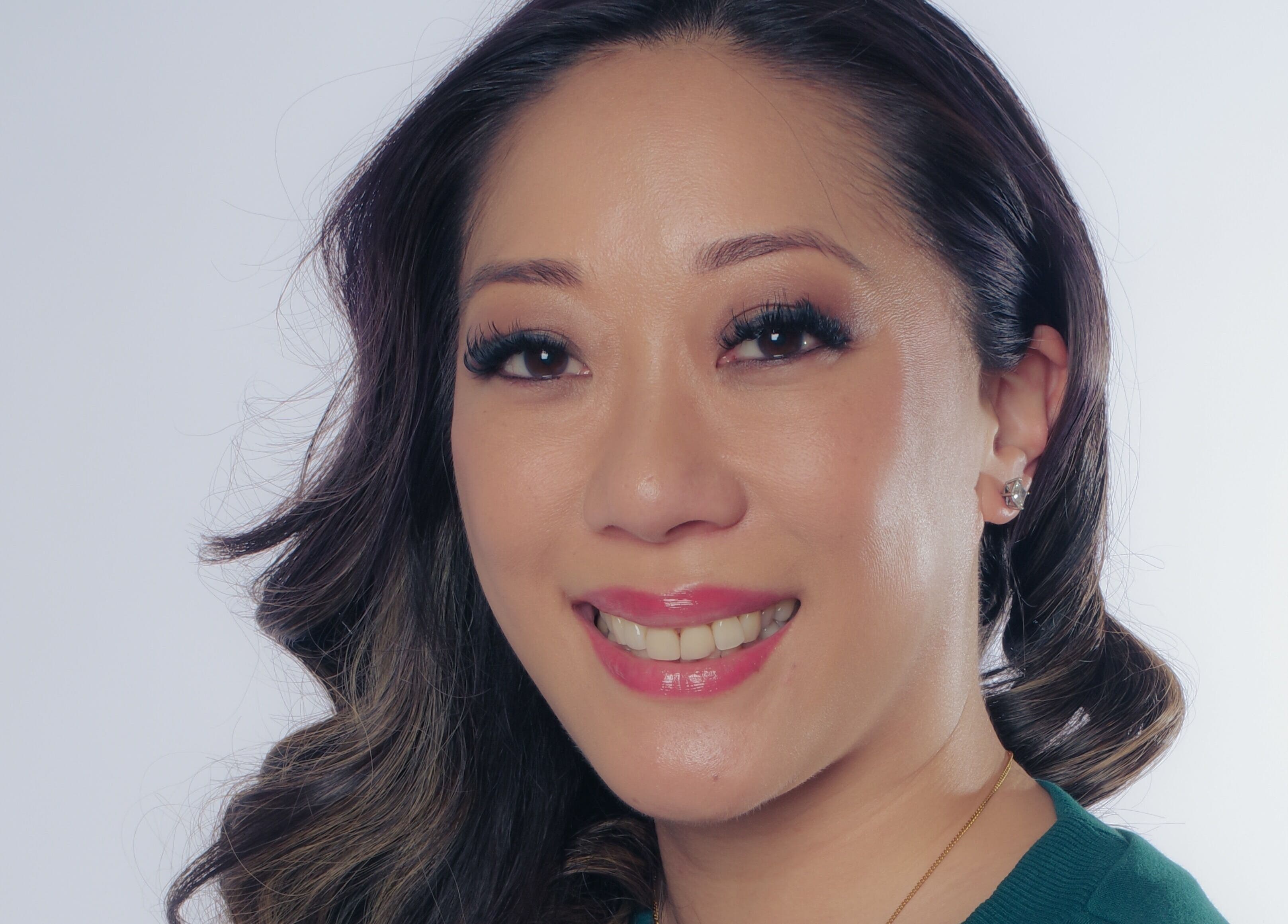 Client with radiant smile after beauty treatment at Fine Line Studios, London, England, GB.