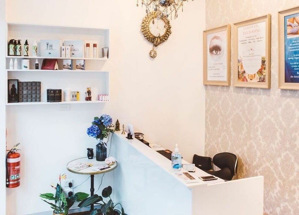 Reception desk at Beauty Brow and Lash Bar, Prahran, Victoria, AU featuring elegant decor and skincare products.