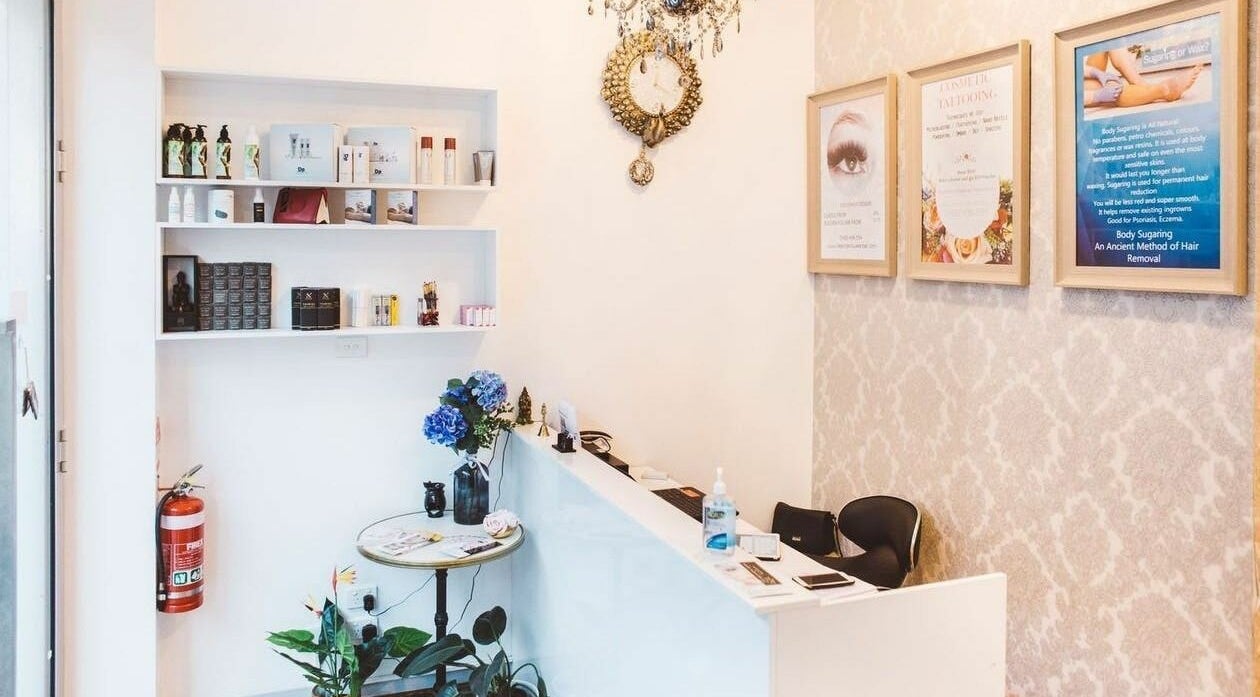 Reception desk at Beauty Brow and Lash Bar, Prahran, Victoria, AU featuring elegant decor and skincare products.