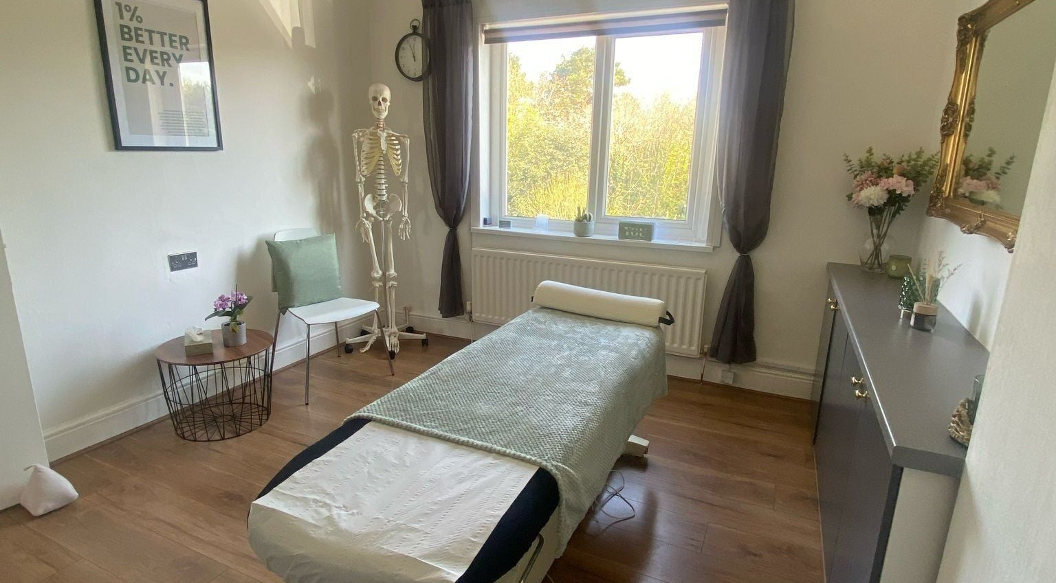 Relaxing therapy room at No Limits Sports Therapy, Redditch, England, GB, featuring massage table and natural light.