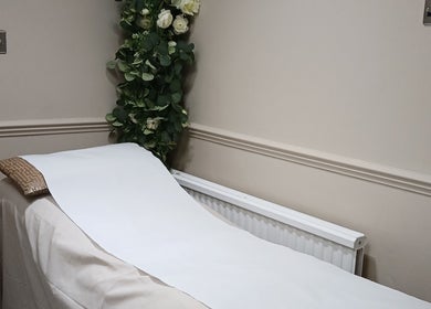 Tranquil therapy bed with floral decor at Kaya's Beauty, London, England, GB.