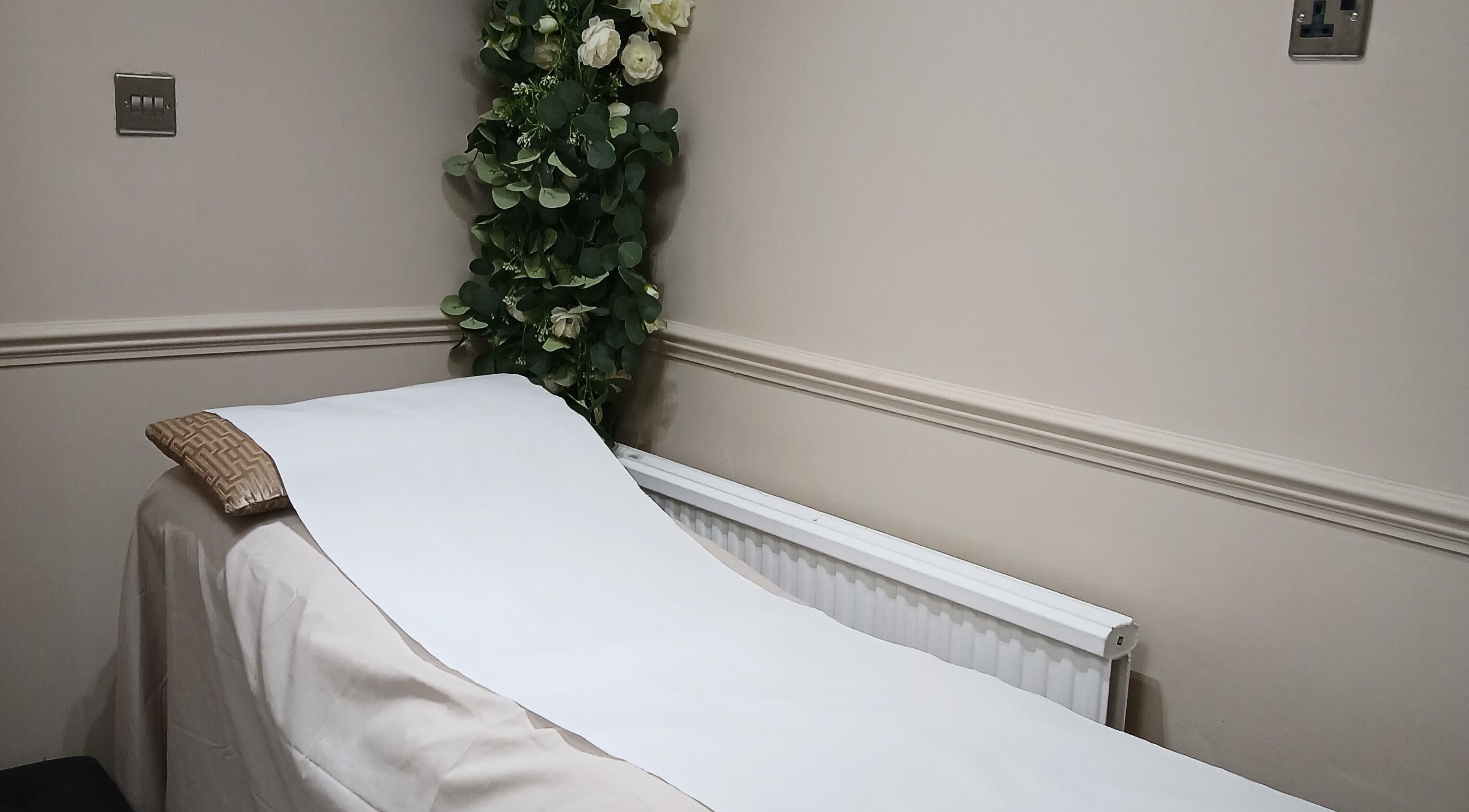 Tranquil therapy bed with floral decor at Kaya's Beauty, London, England, GB.