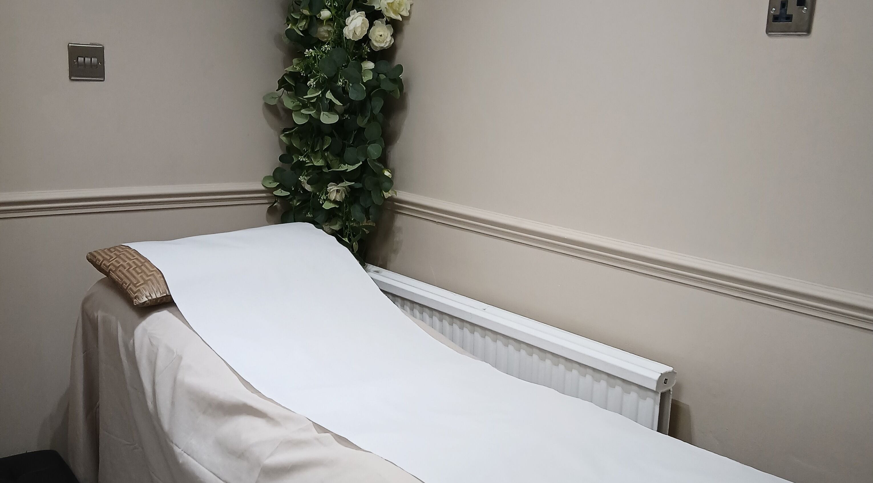 Tranquil therapy bed with floral decor at Kaya's Beauty, London, England, GB.