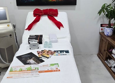 Treatment room at Skash, Cape Town, Western Cape, ZA, featuring a laser machine and skincare items.