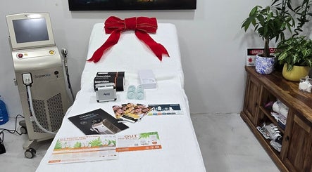 Treatment room at Skash, Cape Town, Western Cape, ZA, featuring a laser machine and skincare items.