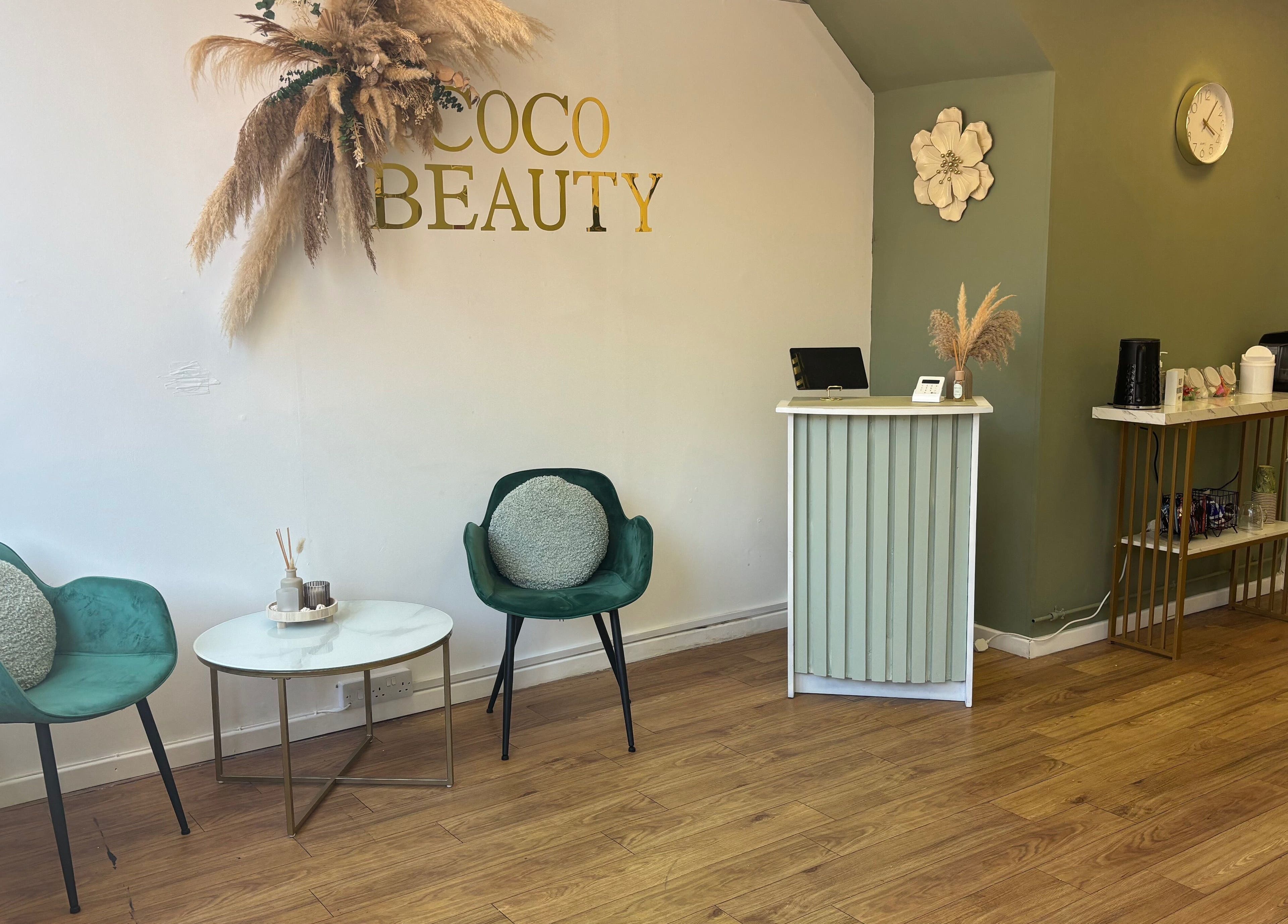 Welcoming reception area at Coco Beauty, Redruth, England, GB with elegant seating and decor.