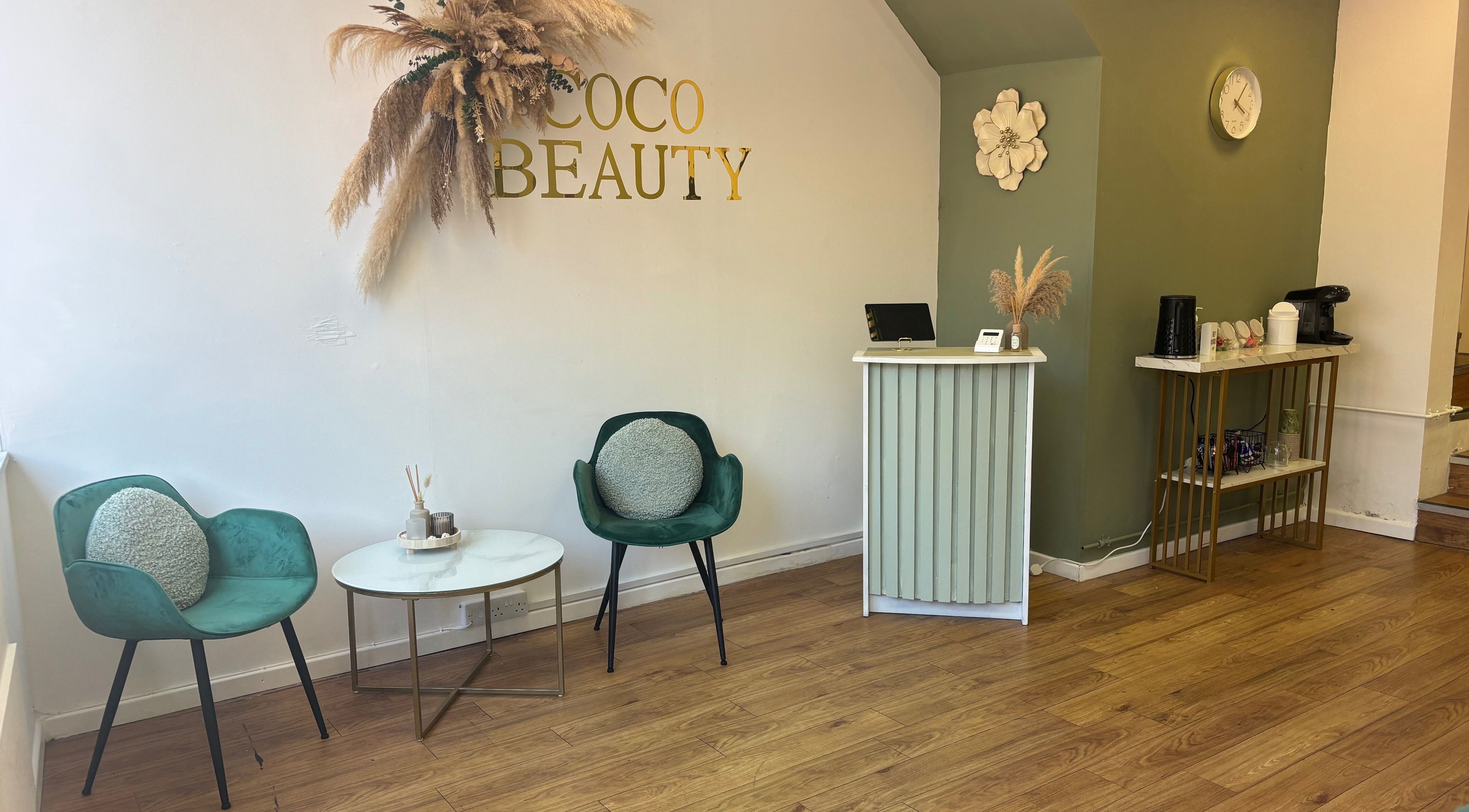 Welcoming reception area at Coco Beauty, Redruth, England, GB with elegant seating and decor.