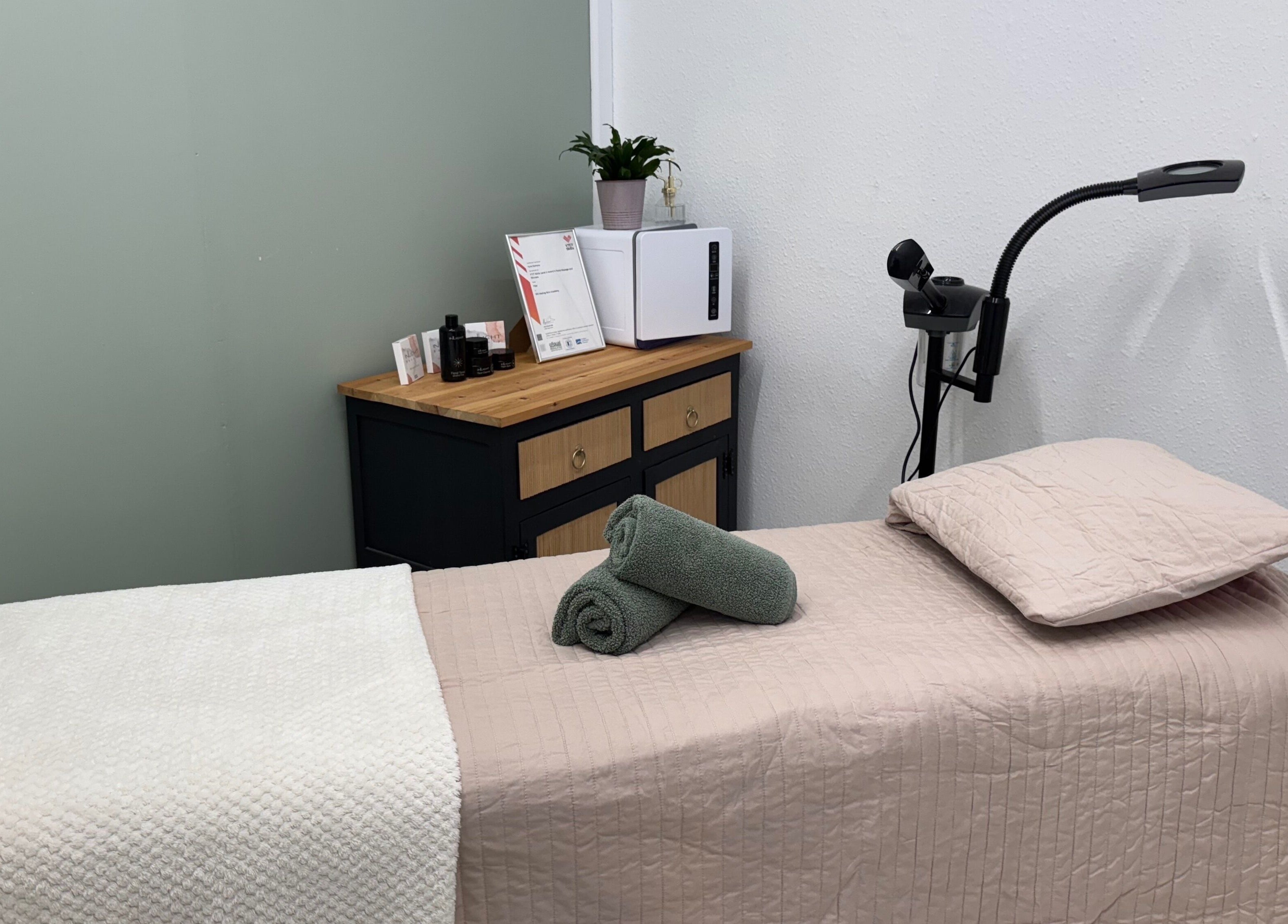 Cozy treatment room at Coco Beauty in Redruth, England, GB, featuring a neatly prepared massage table.
