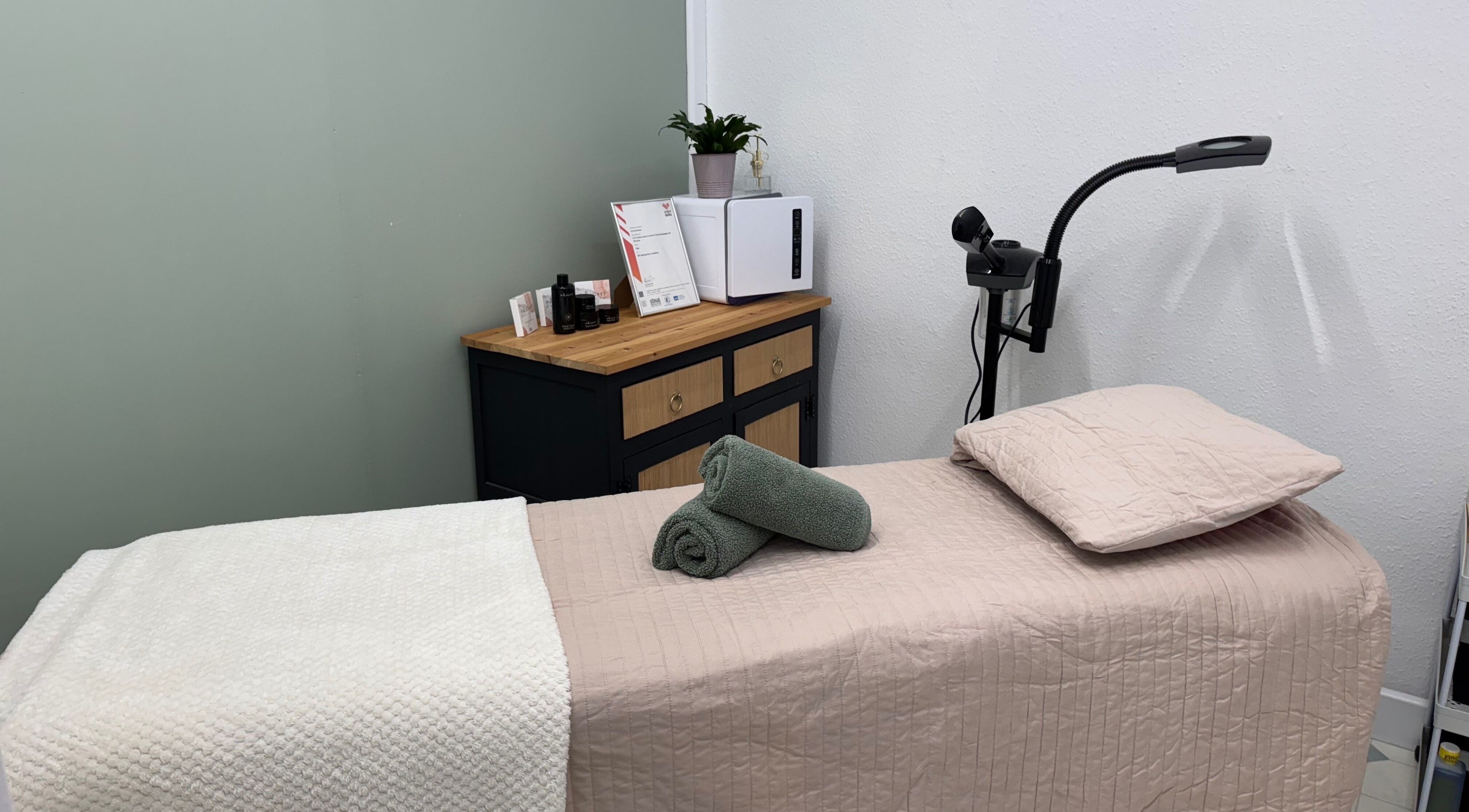 Cozy treatment room at Coco Beauty in Redruth, England, GB, featuring a neatly prepared massage table.