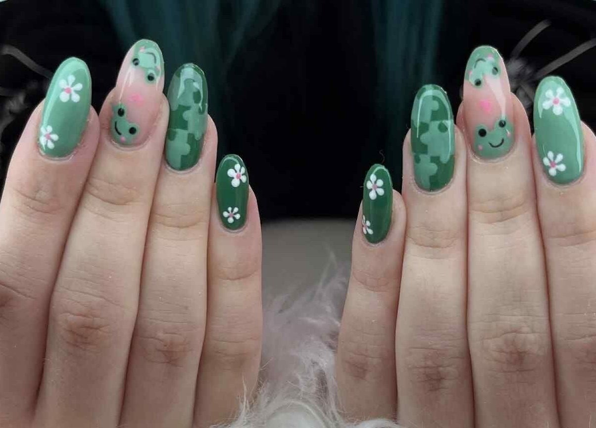 Green nails with floral and smiley design at Coco Beauty in Redruth, England, GB.