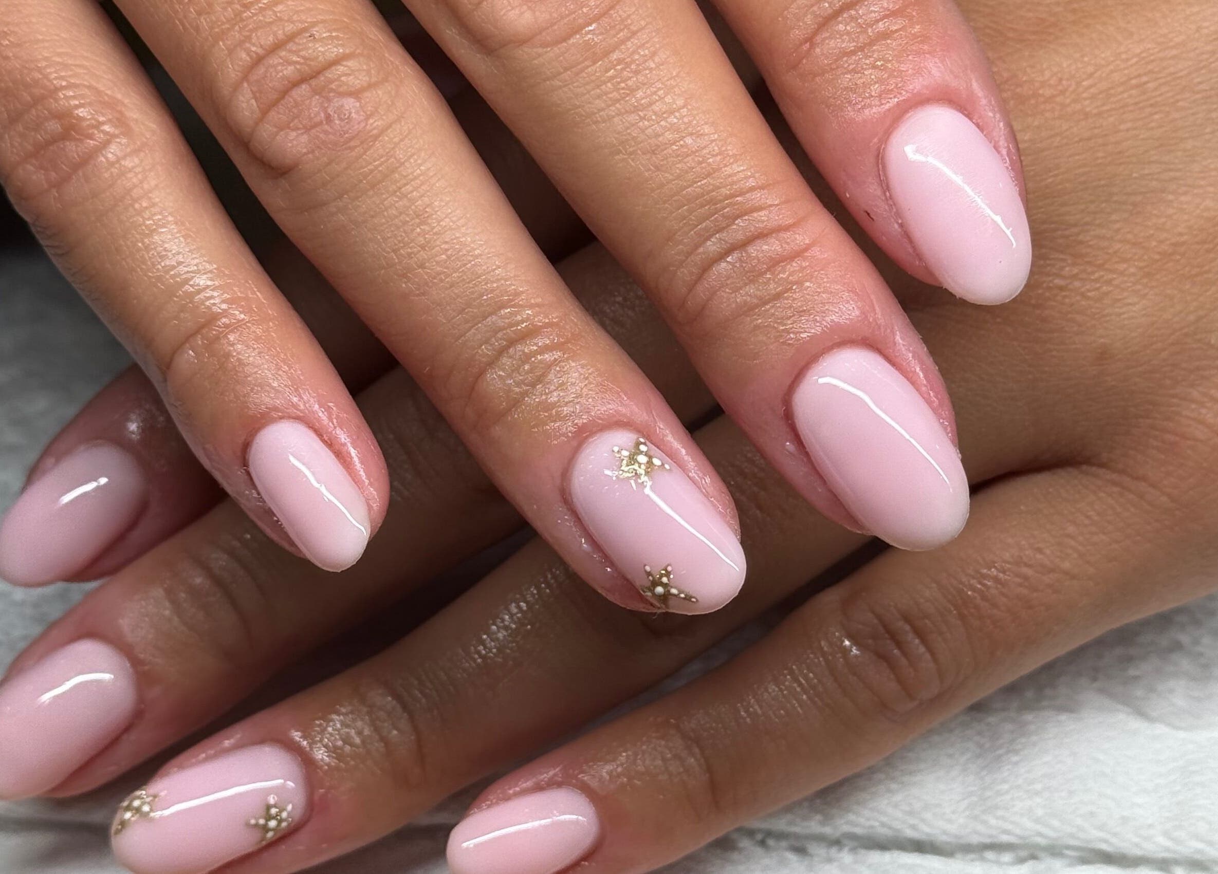 Nail art featuring pink polish and gold accents at Lavish Touch Dundee, Dundee, Scotland, GB.