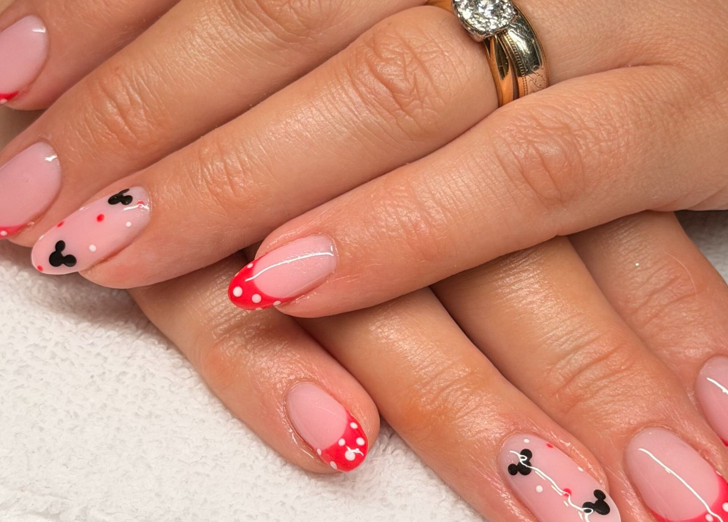Nail art design with red tips and polka dots at Lavish Touch Dundee, Dundee, Scotland, GB.