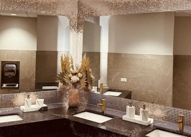 Luxurious bathroom vanity at Silky | The Healthy Hair Experts, New York, New York, US with gold accents.