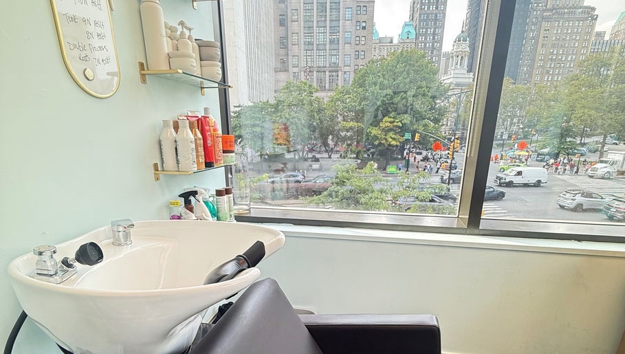 Sleek salon wash station at Silky | The Healthy Hair Experts, New York, New York, US, with cityscape view.