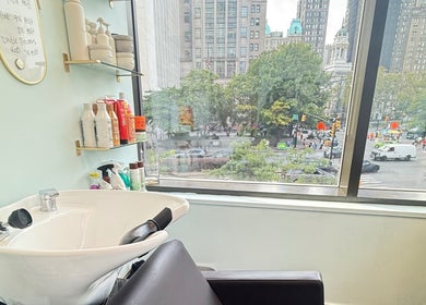 Sleek salon wash station at Silky | The Healthy Hair Experts, New York, New York, US, with cityscape view.