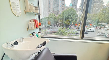 Sleek salon wash station at Silky | The Healthy Hair Experts, New York, New York, US, with cityscape view.