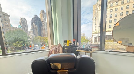 Chic styling chair at Silky | The Healthy Hair Experts, New York, New York, US, overlooking the cityscape.