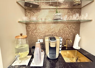 Beverage station at Silky | The Healthy Hair Experts in New York, New York, US offering coffee and infused water.