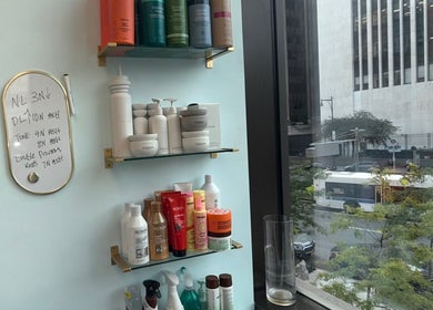 Haircare products on display at Silky | The Healthy Hair Experts, New York, New York, US, overlooking city street.